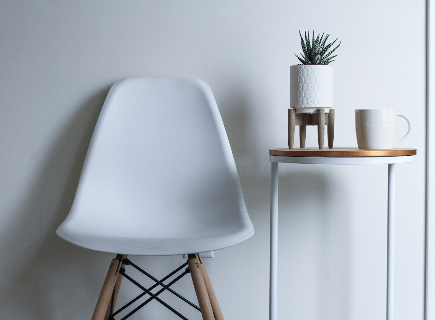 A cherry reading armchair in a quiet corner, leather seat catching morning light
